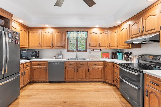 241 New London Rd, Colchester, CT 06415 - kitchen featuring appliances with stainless steel finishes, under cabinet range hood, light wood finished floors, a sink, and brown cabinetry