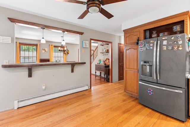 241 New London Rd, Colchester, CT 06415 - kitchen with stainless steel fridge with ice dispenser, a baseboard radiator, ceiling fan, light wood-style floors, and brown cabinets