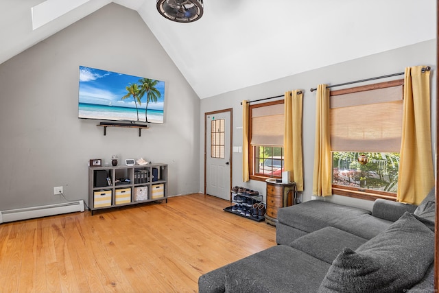 241 New London Rd, Colchester, CT 06415 - living room featuring lofted ceiling, wood finished floors, a skylight, and a baseboard heating unit