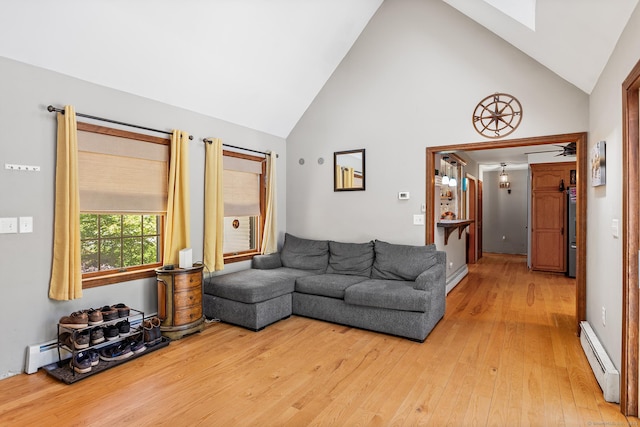 241 New London Rd, Colchester, CT 06415 - living area with a baseboard radiator, high vaulted ceiling, light wood-type flooring, baseboard heating, and a skylight