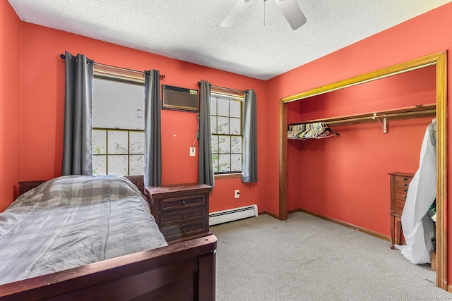 241 New London Rd, Colchester, CT 06415 - unfurnished bedroom featuring baseboard heating, a wall mounted AC, a textured ceiling, carpet flooring, and a closet