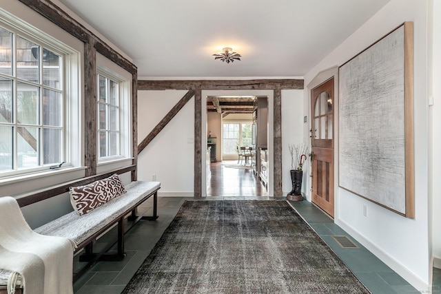 tiled foyer featuring baseboards