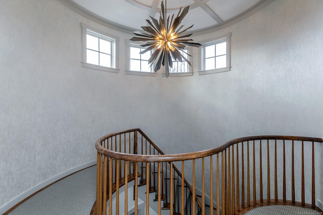 stairway with a chandelier, carpet, and baseboards