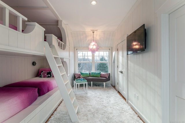 bedroom with wooden walls