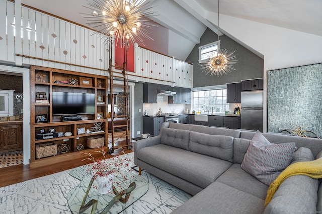 living area with a chandelier, high vaulted ceiling, wood finished floors, and beamed ceiling