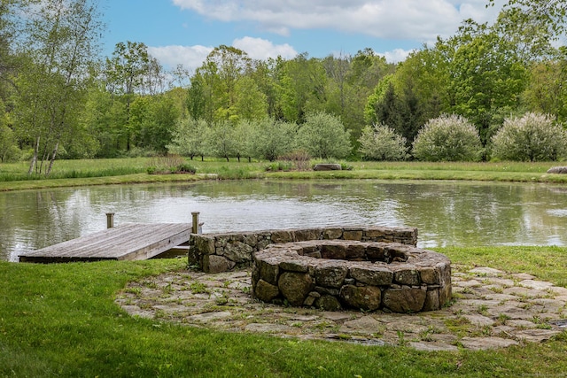 dock with an outdoor fire pit and a water view