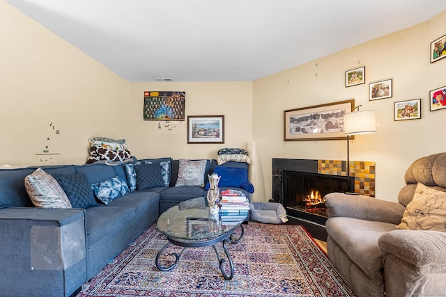 living room featuring a lit fireplace