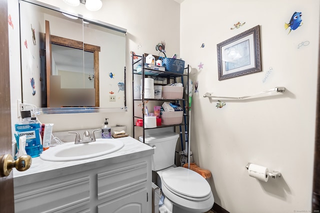 bathroom with toilet and vanity