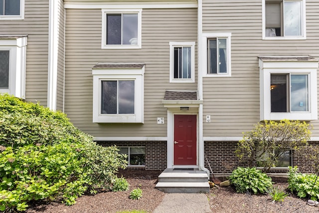view of exterior entry with brick siding