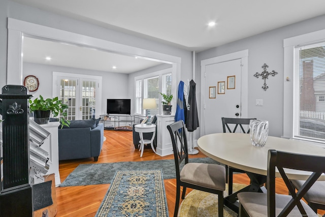 dining area featuring wood finished floors, french doors, and recessed lighting