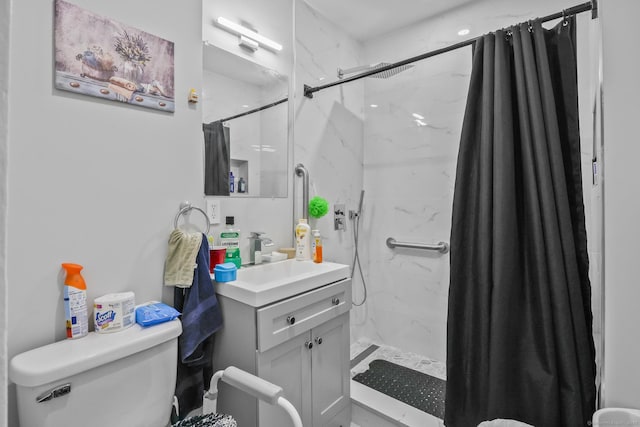 bathroom featuring a marble finish shower, vanity, and toilet