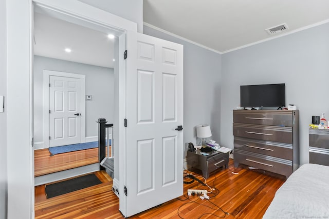 bedroom featuring dark wood finished floors and ornamental molding