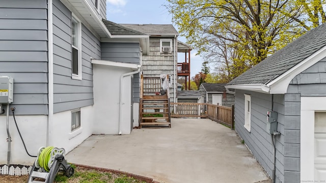 view of patio with stairway and fence
