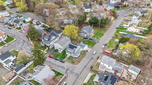 aerial view of property and surrounding area featuring nearby suburban area