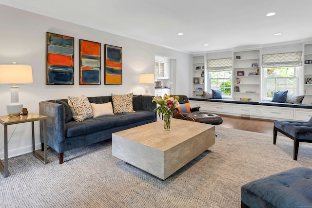 living room with crown molding, recessed lighting, and light wood-type flooring