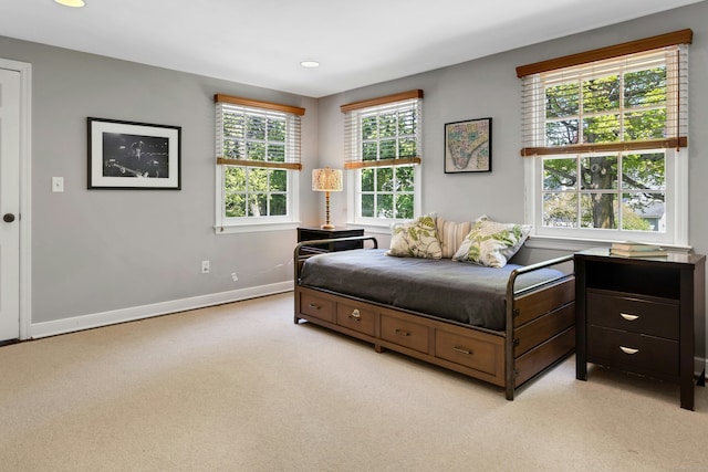 bedroom featuring baseboards, light colored carpet, and recessed lighting