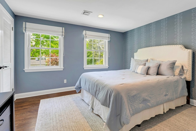 bedroom featuring baseboards, wood finished floors, and recessed lighting