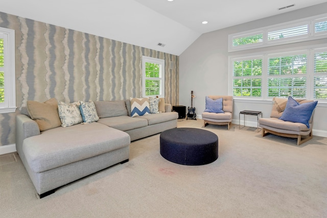 living room with baseboards, vaulted ceiling, and carpet floors