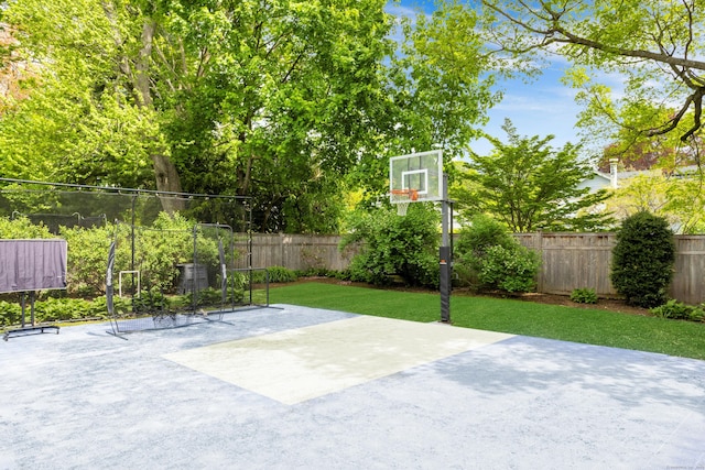 view of sport court with basketball hoop