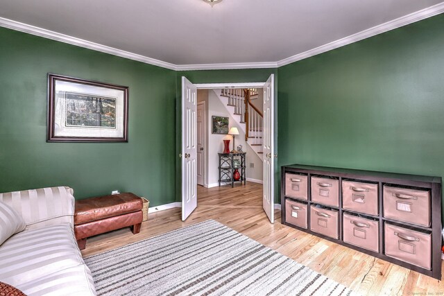 539 Plains Rd, Milford, CT 06461 - sitting room with light wood-type flooring, baseboards, stairway, and ornamental molding