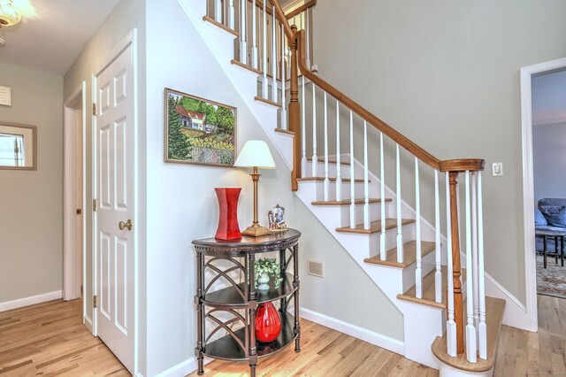 539 Plains Rd, Milford, CT 06461 - staircase featuring wood finished floors and baseboards
