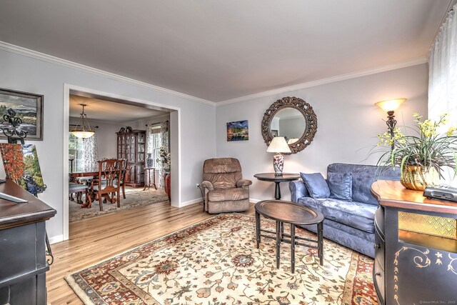 539 Plains Rd, Milford, CT 06461 - living area featuring wood finished floors, crown molding, and baseboards