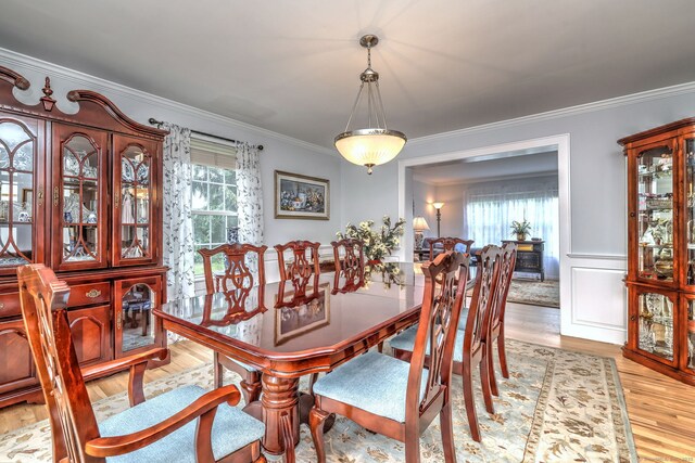 539 Plains Rd, Milford, CT 06461 - dining space with crown molding, light wood-type flooring, healthy amount of natural light, and a wainscoted wall