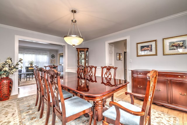 539 Plains Rd, Milford, CT 06461 - dining area with light wood-style floors and ornamental molding
