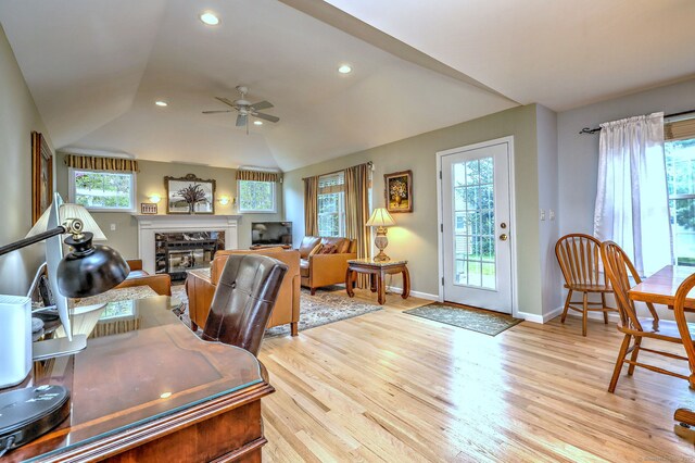 539 Plains Rd, Milford, CT 06461 - office with a ceiling fan, a glass covered fireplace, light wood-type flooring, vaulted ceiling, and baseboards