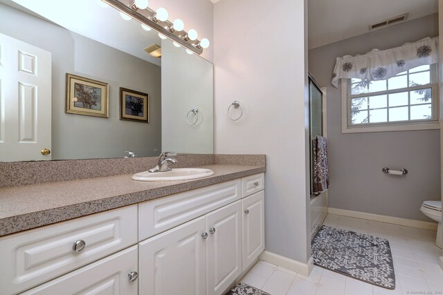 539 Plains Rd, Milford, CT 06461 - bathroom featuring toilet, vanity, tile patterned floors, combined bath / shower with glass door, and baseboards