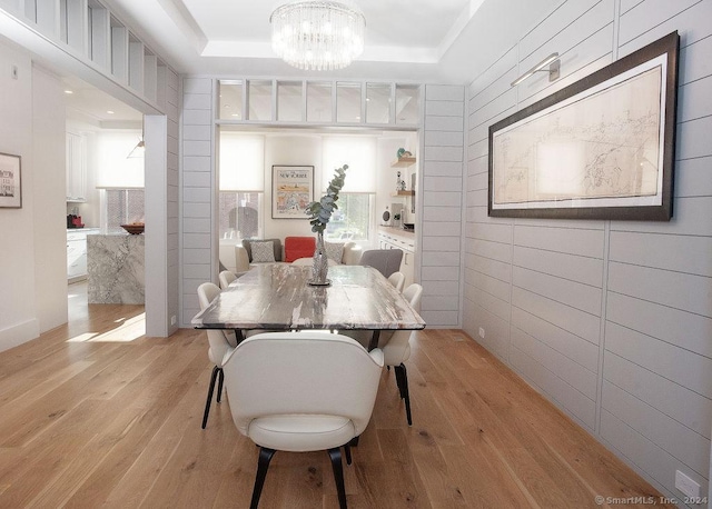 42 Forest St Apt 3, New Canaan, CT 06840 - dining room featuring light wood-style flooring, a raised ceiling, and a chandelier