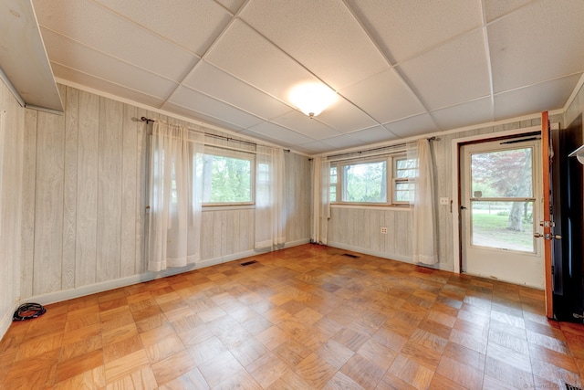empty room with wood walls and baseboards