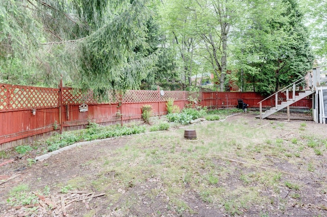 fenced backyard featuring stairs