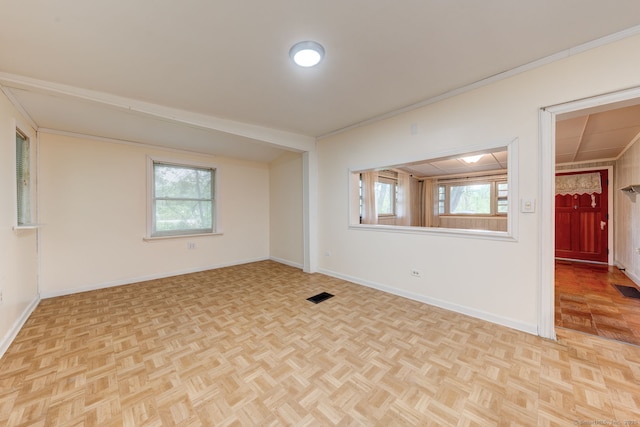 unfurnished room with baseboards and healthy amount of natural light