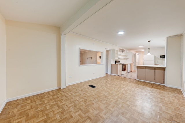 unfurnished living room with baseboards and recessed lighting