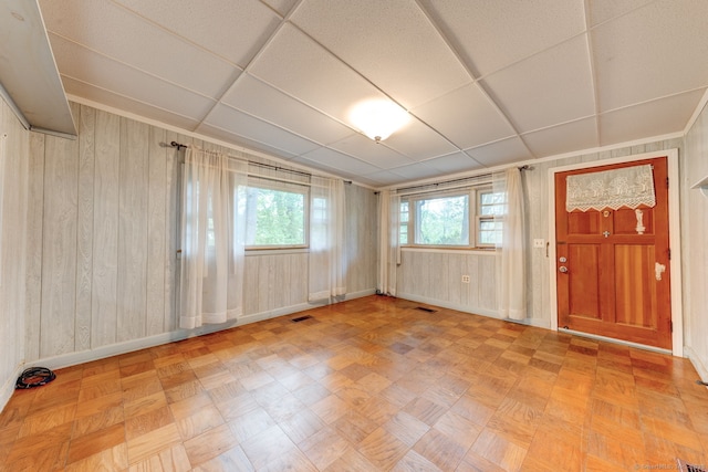 spare room featuring baseboards and wooden walls