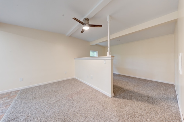 carpeted spare room with a ceiling fan and baseboards