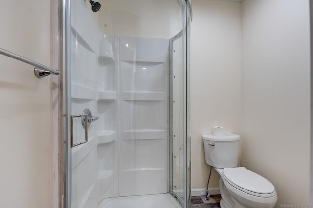 bathroom featuring a shower stall and toilet