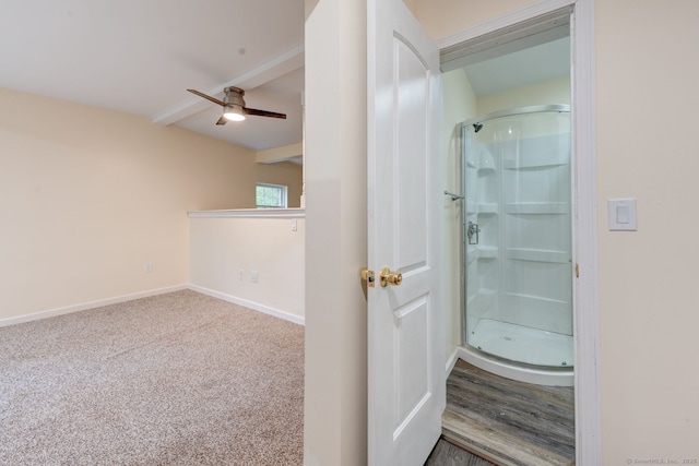 full bathroom with a stall shower, beamed ceiling, ceiling fan, and baseboards