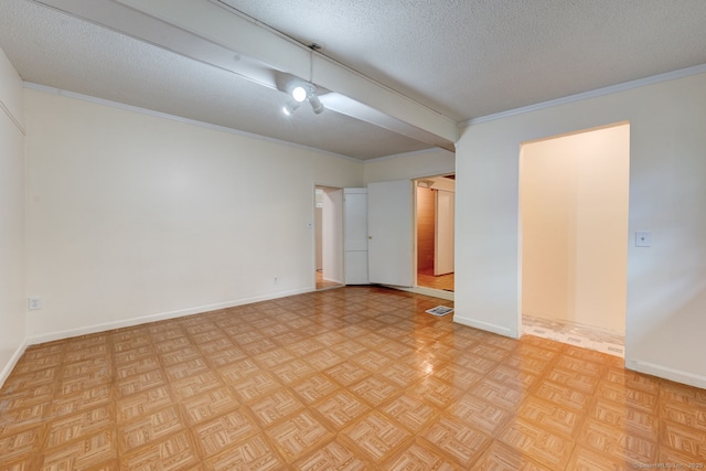 unfurnished room with a textured ceiling, baseboards, and crown molding