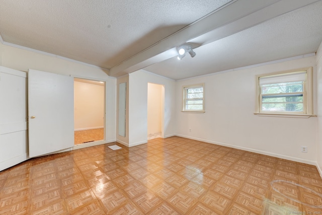 unfurnished bedroom with a textured ceiling and baseboards