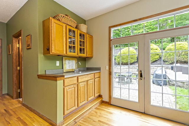 250 Wooding Hill Rd, Bethany, CT 06524 - kitchen featuring light wood-style floors, a sink, glass insert cabinets, and baseboards