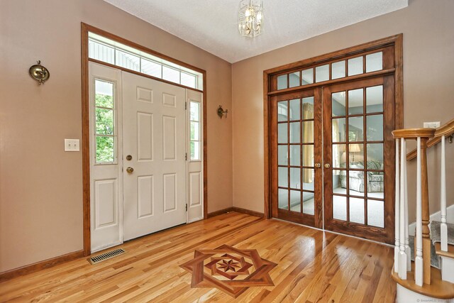 250 Wooding Hill Rd, Bethany, CT 06524 - entryway with french doors, light wood-type flooring, stairway, and baseboards