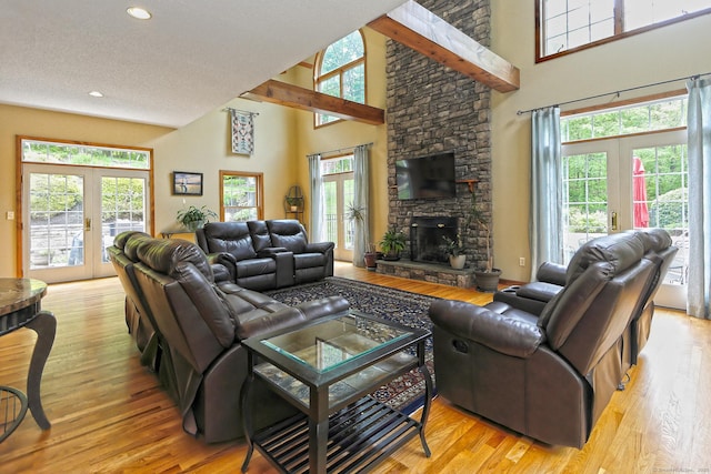 250 Wooding Hill Rd, Bethany, CT 06524 - living area with wood finished floors, french doors, a towering ceiling, a fireplace, and recessed lighting