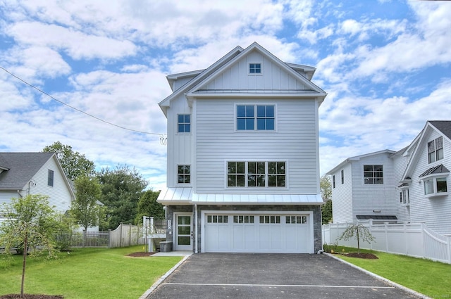 450 Penfield Rd, Fairfield, CT 06824 - coastal inspired home featuring board and batten siding, asphalt driveway, an attached garage, and stone siding