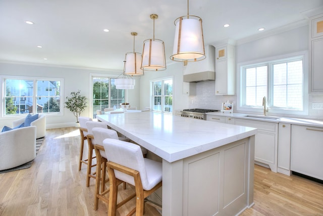 450 Penfield Rd, Fairfield, CT 06824 - kitchen with a sink, a kitchen island, light wood-type flooring, white cabinetry, and recessed lighting