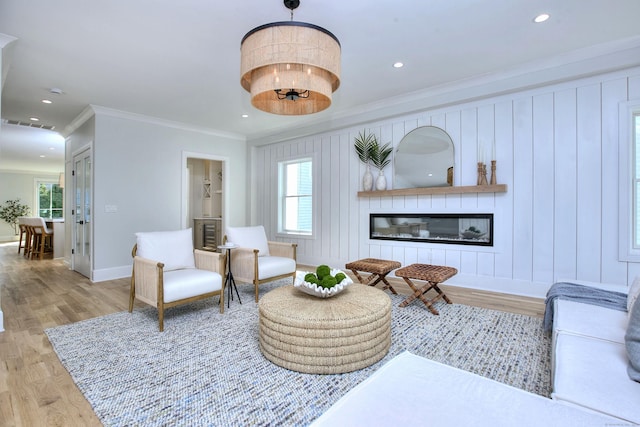 450 Penfield Rd, Fairfield, CT 06824 - living area with crown molding, wood finished floors, baseboards, recessed lighting, and a glass covered fireplace
