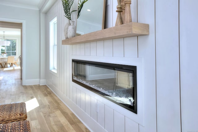 450 Penfield Rd, Fairfield, CT 06824 - detailed view of a glass covered fireplace, wood finished floors, ornamental molding, and baseboards