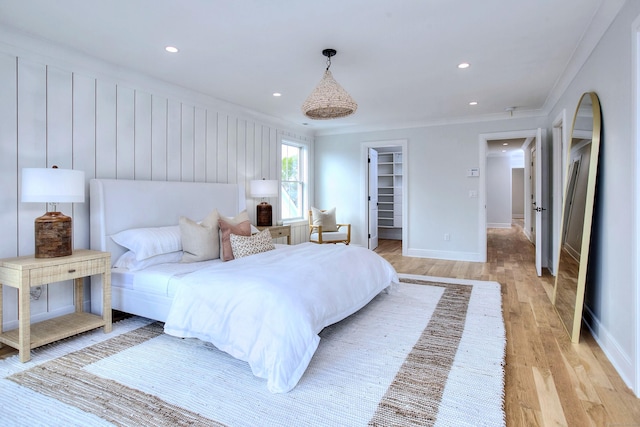 450 Penfield Rd, Fairfield, CT 06824 - bedroom with light wood-style flooring, ornamental molding, a walk in closet, recessed lighting, and baseboards