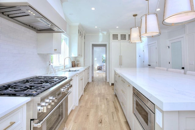 450 Penfield Rd, Fairfield, CT 06824 - kitchen featuring custom range hood, appliances with stainless steel finishes, a sink, white cabinetry, and light wood-style floors
